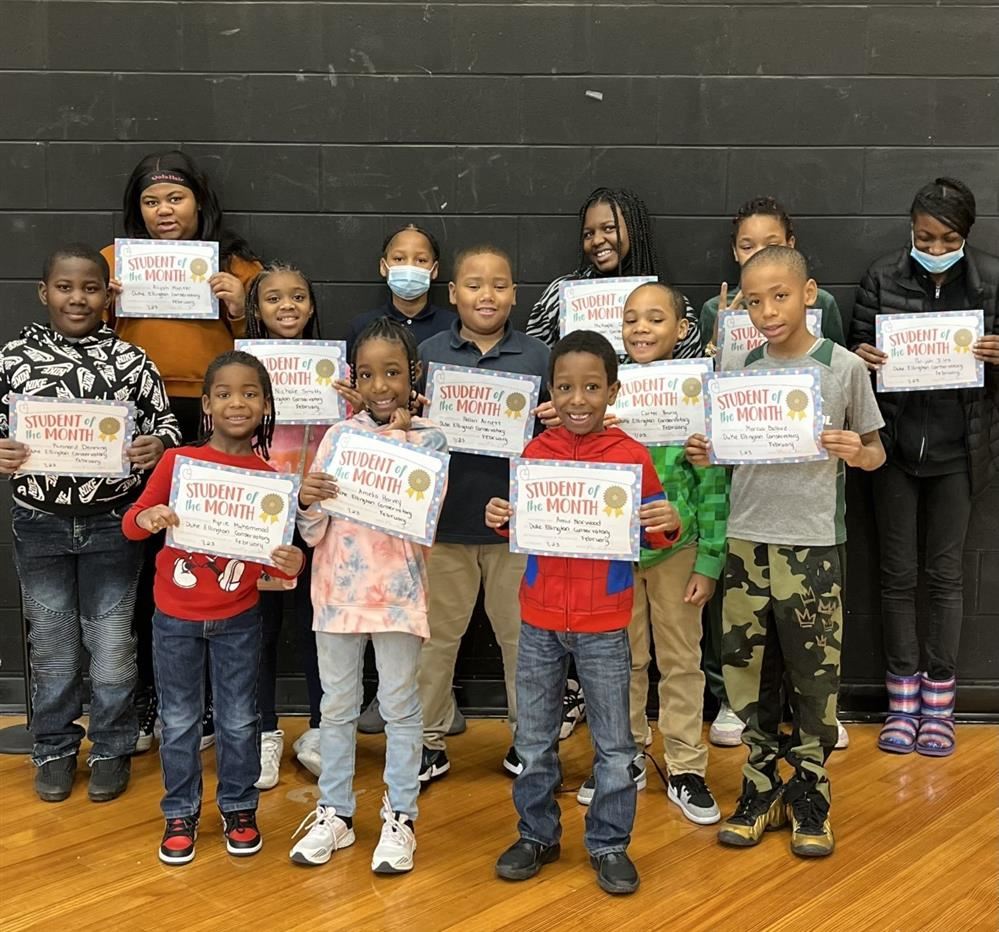  Students holding their student of month the certificates